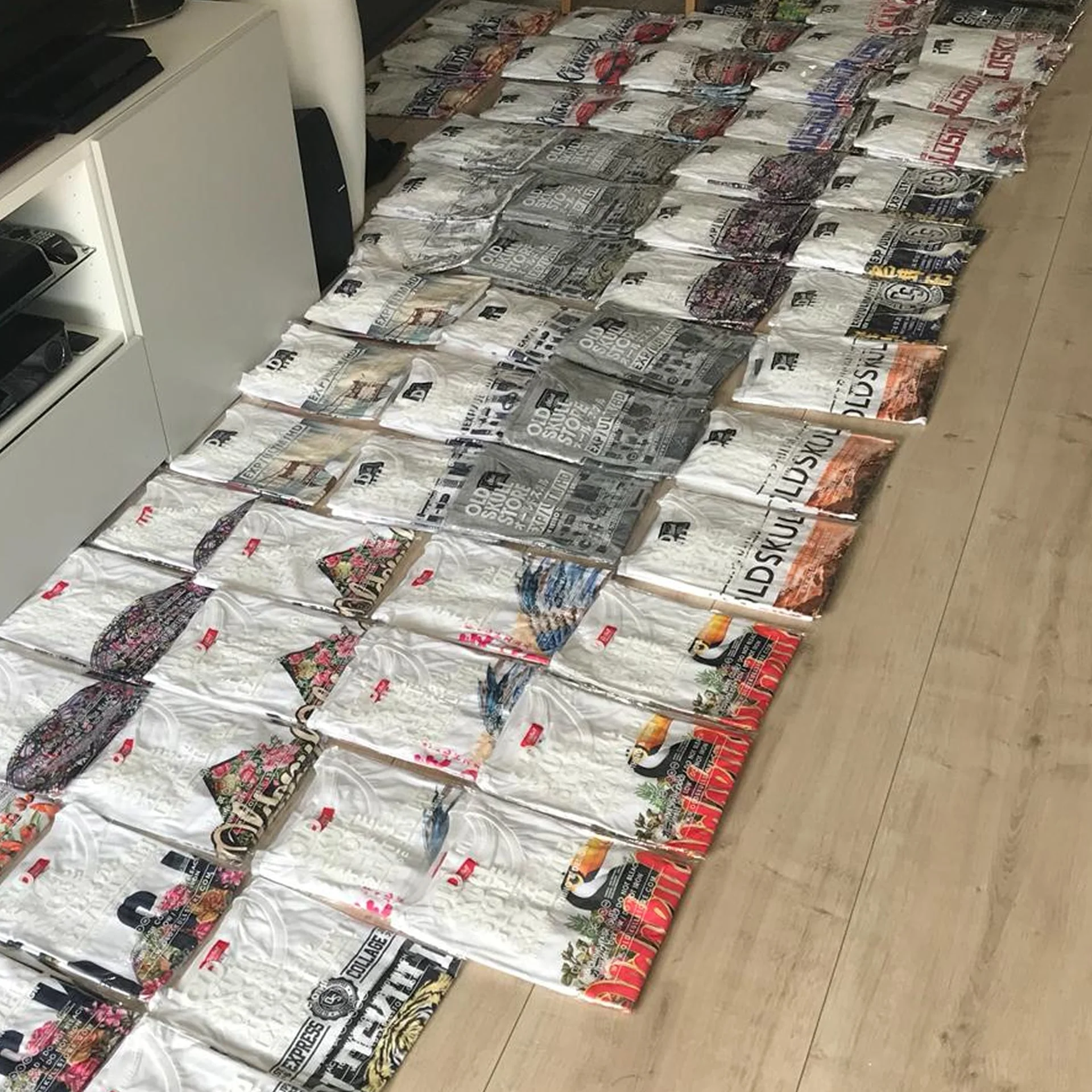 First batch of packaged Oldskull shirts laid out on the floor